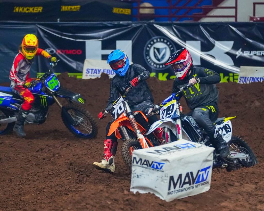 Riders getting close while turning during an AMA Arenacross race.